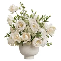 Elegant White Flowers Arrangement In White Vase With Green Leaves And Small Blossoms