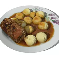 Roast Meat Roll With White Potato Balls In Brown Sauce On Decorative Plate