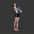 Woman Smiling While Holding Blue Items Wearing Black Shorts And Pink Sneakers On Gray Background