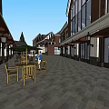 Traditional And Modern Buildings On Commercial Street With Outdoor Seating And Street Lamps