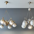 Lighted Modern Golden And Silver Chandeliers With Spherical Glass Shades Hanging From Ceiling