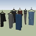 Stylish Assorted Color Pants Hanging On Wooden Hangers With Different Textures And Casual Styles