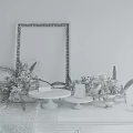 Console Table with Gray Wall Wooden Floor Mirror Floral Decorations Candlesticks and Draped Tablecloth
