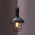 Industrial Style Black Metal Pendant Light With Cage Shade And Illuminated Bulb On Gray Wall
