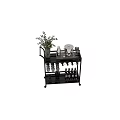 Dinnerware Set on Metal Multi-layer Trolley with Wine Glasses Wine Bottles and Green Plants
