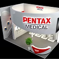 PENTAX MEDICAL Circular Exhibition Booth With Staircase Displayed Products And Reception Desk