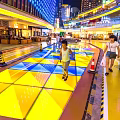 Vibrant Nighttime Commercial Landscape With Neon Signs Multi Level Buildings And Pedestrians