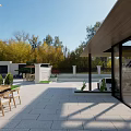 Detached Villa With White Exterior Black Roof Wrought Iron Gate Surrounded By Trees