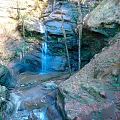 Natural Garden Landscape Featuring Scenic Waterfall Flowing Through Rocky Terrain Lush Trees And Clear Stream