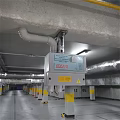 Ceiling Mounted Fire Safety Equipment In Underground Parking Garage With Yellow Pillars And Pipes