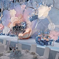 Elegant Banquet Hall With Floral Decorations Hanging Installations And White Chairs