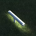 White Rectangular Outdoor Light with Stand Glowing on Green Grass Illuminating Lawn