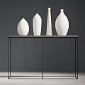 Four White Vases Arranged On Black Metal Frame Table Against Dark Gray Wall
