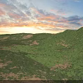 Stunning Colorful Sunset Sky Over Lush Green Rolling Grassy Hills Beautiful Outdoor Natural Landscape