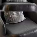 Modern Black Leather Armchair With Plaid Pillow And Decorative Buttons