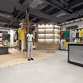 Modern Clothing Store Interior Featuring Displayed T-shirts Colorful Apparel Comfortable Chairs And Table
