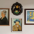 Framed Artworks Including Portraits And Abstract Paintings Hanging On Wall