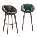 Modern Bar Stools With Green And Beige Padded Seats And Wooden Legs