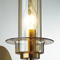 Modern Brass Wall Lamp With Transparent Glass Shade And Exposed Bulb Decorative Design