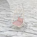 White Woven Swing Chair With Pink Cushion In Green Grass Field