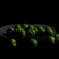 Healthy fresh green fruits placed on and around gray ceramic plate
