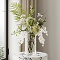 Clear Glass Vase with White Orchids Green Hydrangeas Palm Leaves and Greenery on Window Table