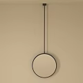 Modern Round Mirror With Black Frame Hanging On Beige Wall