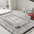 Leisure Chair with Red Blanket on Large Area Rug Featuring Books Vase and Framed Artwork