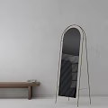 Modern Arched Floor Mirror With Metal Frame And Wooden Table In Interior