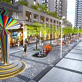 Modern Commercial Pedestrian Street With Trees Shops And Central Sculpture