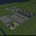 Aerial View of Industrial Factory Complex With Multiple Buildings Greenery Roads and Circular Ponds