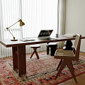 Wooden Desk With Brass Lamp Laptop Wicker Chair And Patterned Rug Near Window Blinds