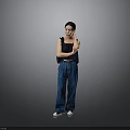 Stylish Woman In Black Top And Blue Jeans With Crossed Arms Standing Against Gray Background