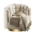 Cozy Beige Velvet Lounge Chair with Fringed Blanket and Gold Base