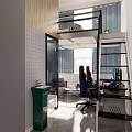 Modern Hotel Room Interior Featuring Loft Style Work Desk Ergonomic Chair and Large Windows