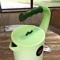 Modern Dining Area With Round Table And Unique Watering Can Decor