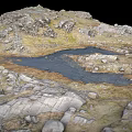 Natural Rocky Terrain With Small Water Pools And Green Grass Patches