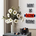 White Flowers In Silver Textured Vase With Figs Decorative Wall Letters And Natural Light