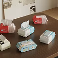 Various Packaged Tissues With Different Colors And Designs On Wooden Table