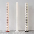 Three Modern Red White Black Floor Lamps With Slender Columnar Patterned Design Against Light Walls