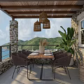 Rustic Living Space With Wooden Ceiling Beams Stone Walls Sofa Kitchen And Woven Tapestry
