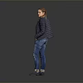 Woman in Dark Jacket and Patterned T-Shirt with Blue Jeans on Gray Background
