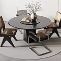 Modern Round Black Dining Table Set With Woven Seat Chairs Silver Vase And Book