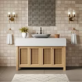 Modern Bathroom With Brick Wall Gold Sconces Wooden Rattan Vanity White Sink And Geometric Rug