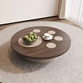 Round Wooden Coffee Table With Dots Green Fruit Bowl And White Cups On Gray Rug