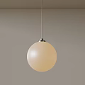 Minimalist Cream Colored Spherical Pendant Light Suspended From Ceiling Against Light Wall