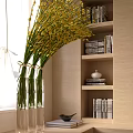 Yellow Flowers in Clear Vase with Bookshelf and Beige Interior Wall