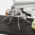 Mechanical Metal Ant Decorative Ornament Set with Stacked Books and Green Apples on Black Table