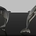 Two Leaping Dolphin Statues With Shiny Surface On Black Background