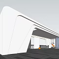 Modern White Entrance Gate With Sleek Curved Design And Spacious Stone Paved Area